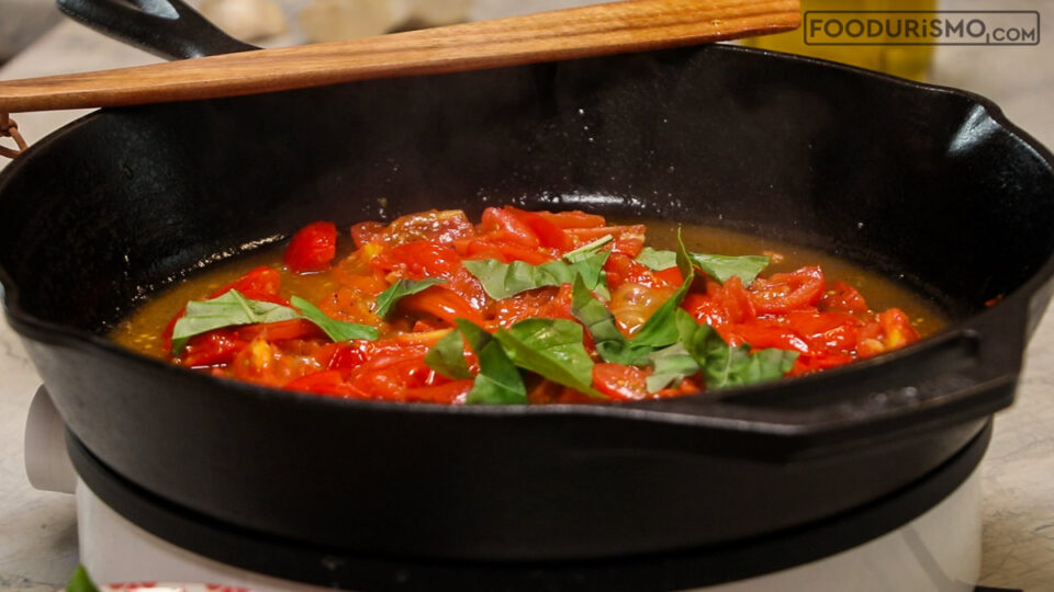 cherry tomatoes and basil in the pan