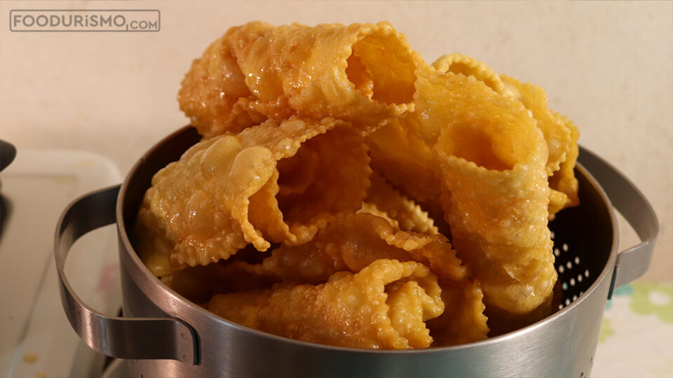 honey-soaked diples in the strainer