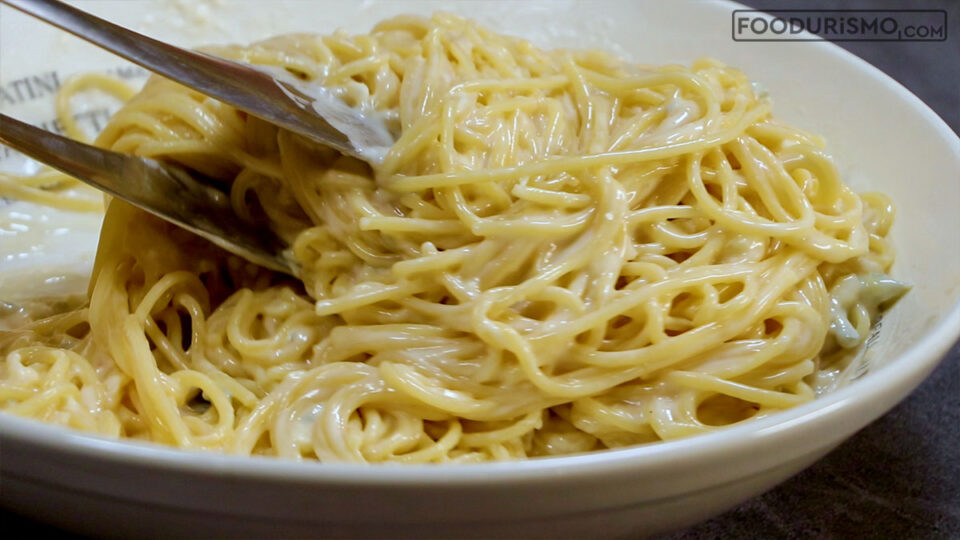 mixing the cream into the pasta
